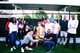 Photo of smiling Southwest Credit employees posing with a Ronald McDonald statue and showing a donation check [Image by creator  from ]